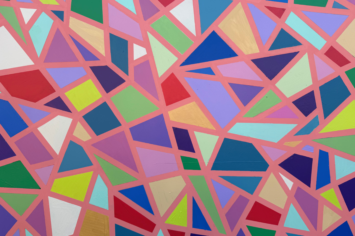 Vibrant abstract mural of irregular polygons in bright colors separated by pink lines.
